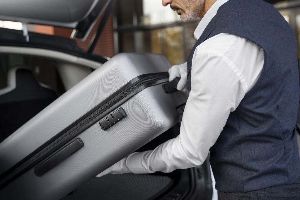 valet holding baggage side view